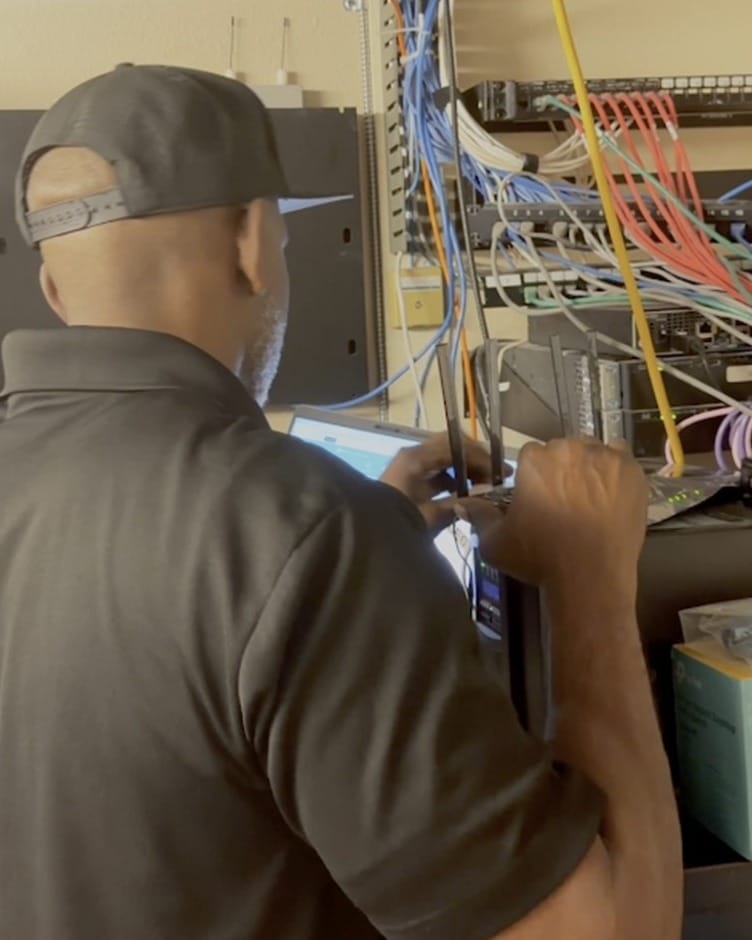 AspireOn technician on site wiring a network rack